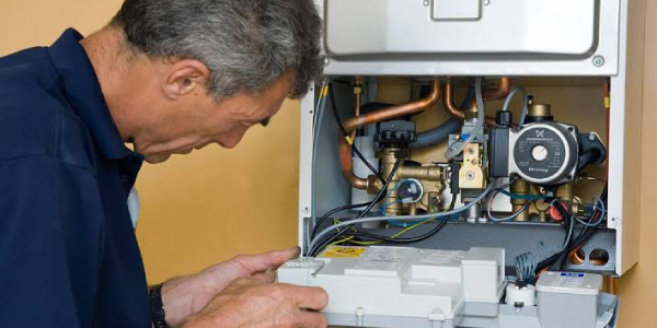 Technician checks and reparing the water boiler.