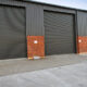 Closed grey roller shutters of an industrial building.