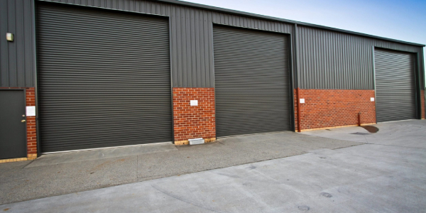 Closed grey roller shutters of an industrial building.
